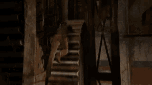 a man is hanging from a rope in a room