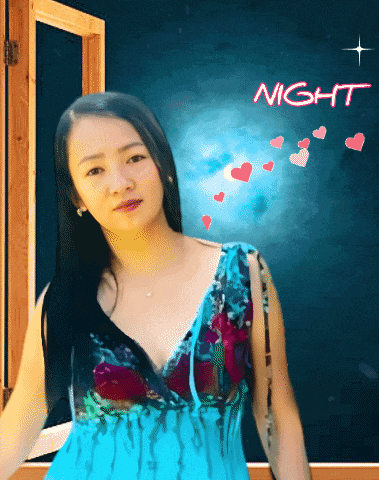 a woman in a blue dress is standing in front of a night sign