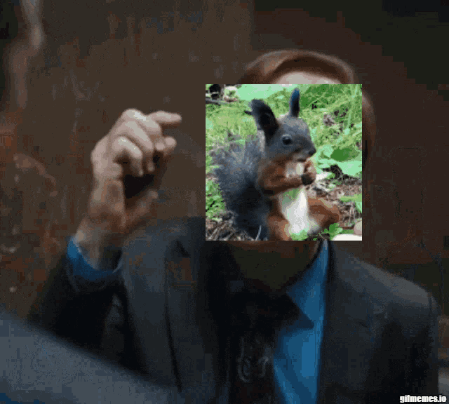 a man holding a picture of a squirrel behind his face