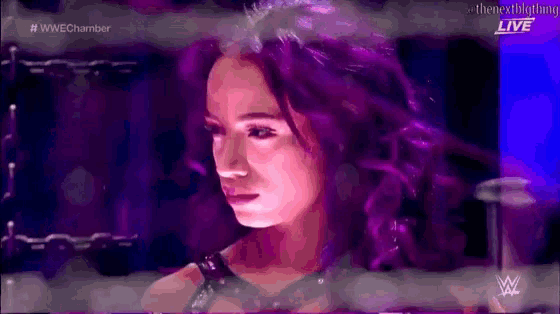 a woman with purple hair is on a wrestling show