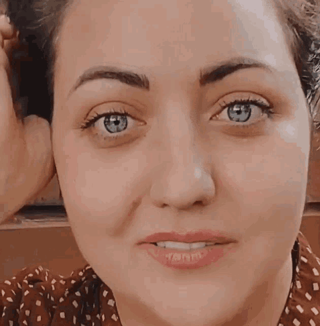 a close up of a woman 's face showing her blue eyes