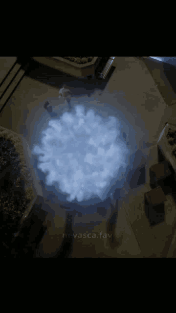 an aerial view of a person standing in a circle of smoke with the website havasca.fav written on the bottom