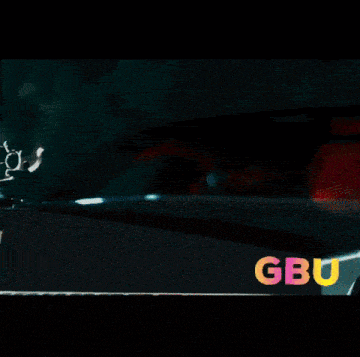 a group of people are dancing in a room with gbu written in the corner