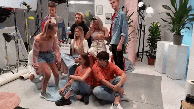 a group of people are posing for a picture in a room .