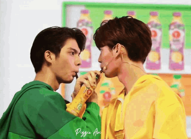 two young men are drinking from a bottle with the word piggy written on it