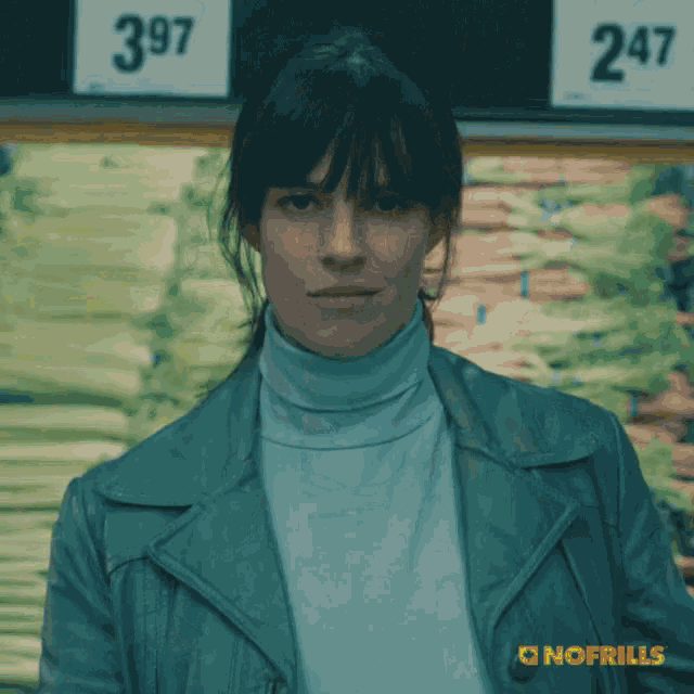 a woman stands in front of a sign that says 297