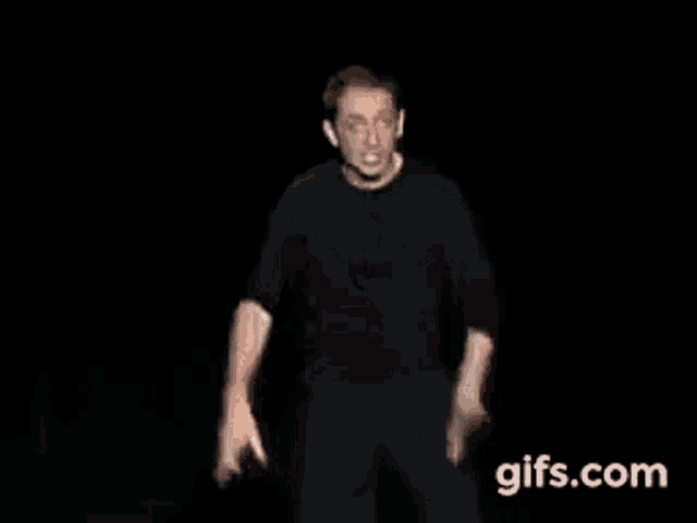 a man in a black shirt is dancing in front of a black background with the words t 'étais ou ?