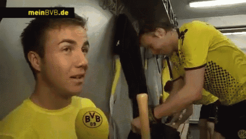 a man wearing a yellow shirt with bvb on the front