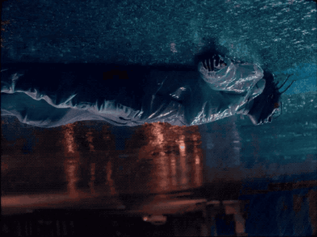 a person in a white jacket is swimming in a pool