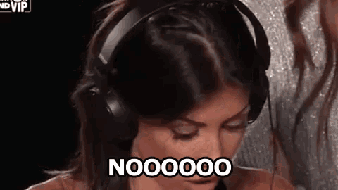 a woman wearing headphones is making a funny face and saying noooooo .