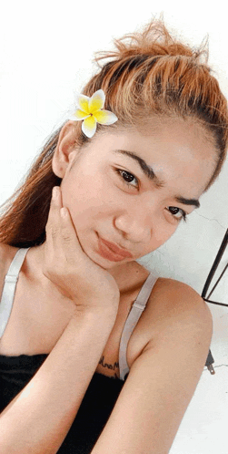 a woman with a flower in her hair has a tattoo that says " dream "