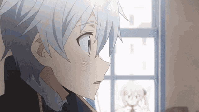 a boy with white hair is looking at something