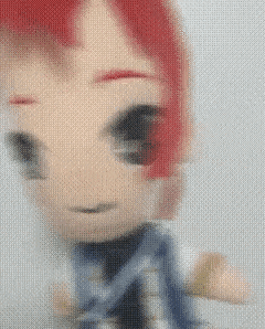 a close up of a doll with red hair on a white background