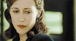 a close up of a woman 's face with a sad look on her face