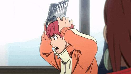 a boy with red hair is holding a magazine over his head