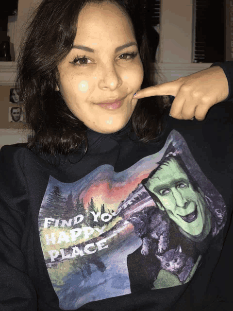 a woman wearing a black sweatshirt with frankenstein on it