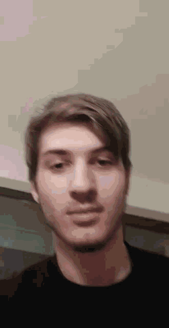 a close up of a man 's face with a beard .