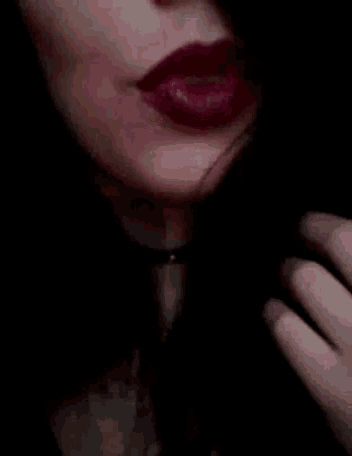 a close up of a woman 's face with red lipstick