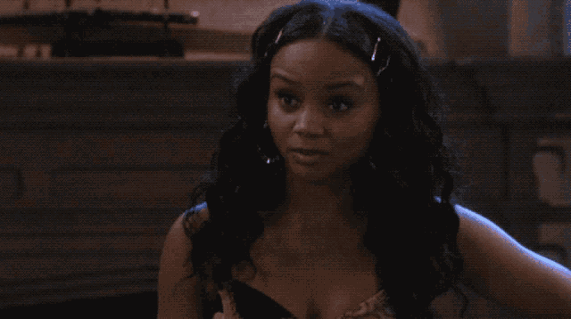 a woman with a surprised look on her face wears hoop earrings