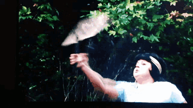 a pixelated image of a person throwing a leaf