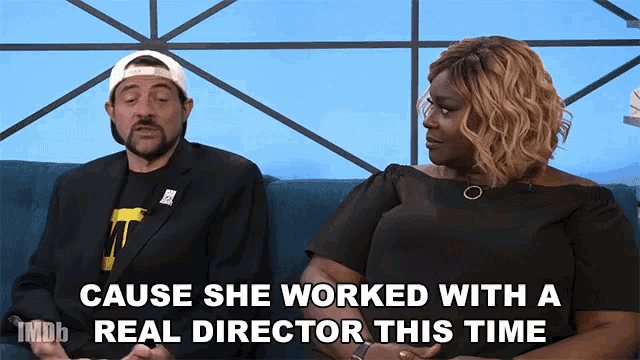 a man and a woman are sitting on a couch and the woman says " cause she worked with a real director "