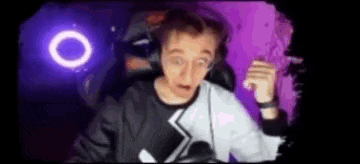 a man wearing headphones is sitting in front of a purple background .
