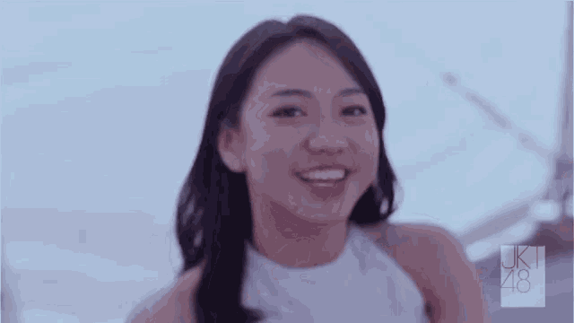 a woman wearing a white top with the number 48 on the bottom