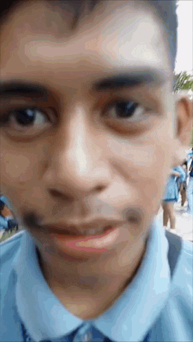 a close up of a man 's face with a beard