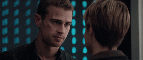 two men are looking at each other and one has a scratch on his face