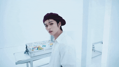 a close up of a person wearing a beret