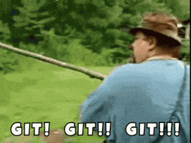 a man in a blue shirt is holding a fishing rod and says git git git !!!