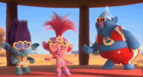 a group of trolls are standing next to each other on a stage .