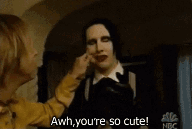 a man with makeup on his face says " aww you 're so cute "