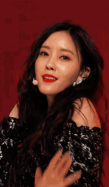 a close up of a woman 's face with red lips and earrings