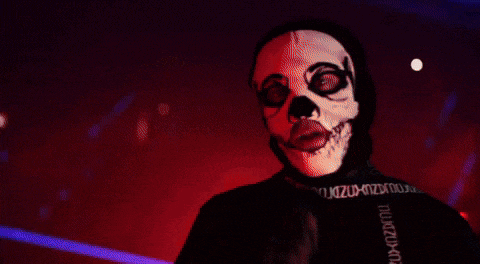 a person wearing a skull mask and a black shirt that says ' n ' on the sleeve