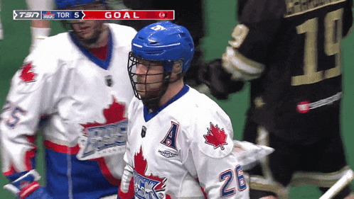 a hockey player wearing a white jersey with a maple leaf on it