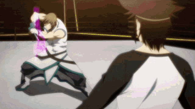 a man in a white shirt is fighting another man in a black shirt in a ring