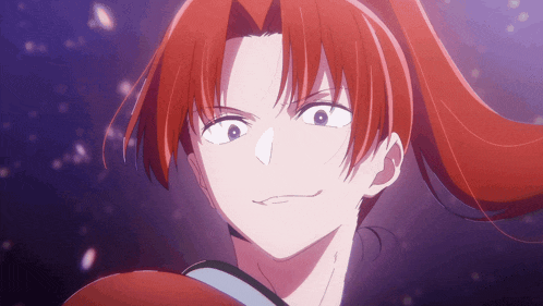 a close up of a person 's face with red hair and blue eyes