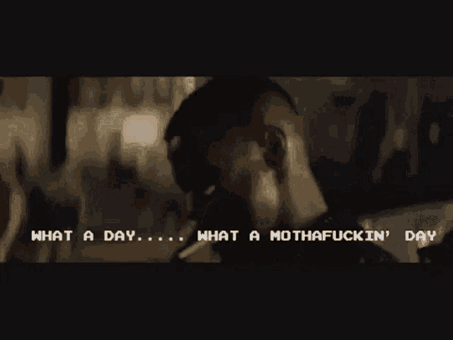 a man is smoking a cigarette and says what a day what a mothafuckin day