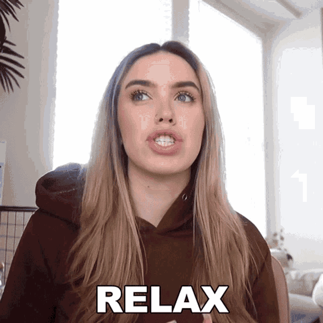 a woman in a brown sweatshirt says relax