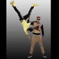 a man is doing a handstand while another man holds him up in the air .