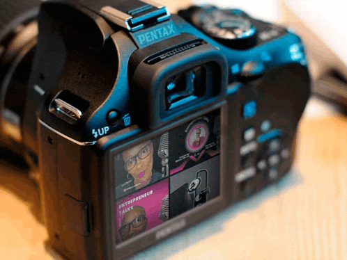 a pentax camera has a screen that shows an entrepreneur talks