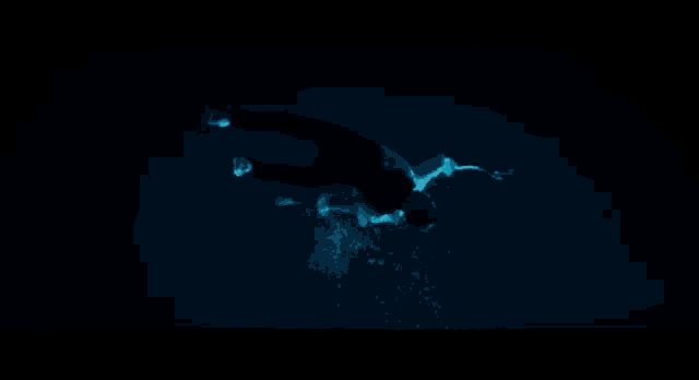 a man in a white shirt is drowning in the ocean