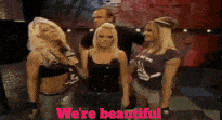 a group of women standing next to each other with the words " we 're beautiful " written in pink