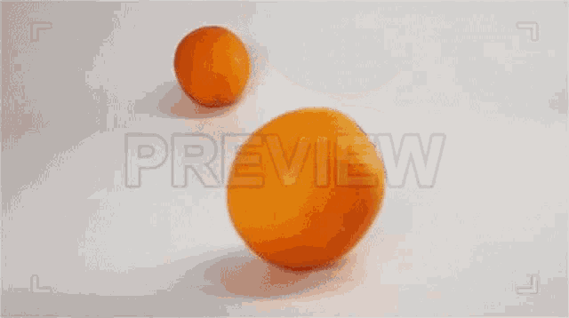 three oranges are falling on a white surface with the word preview below them