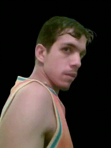 a man without a shirt is looking over his shoulder at the camera
