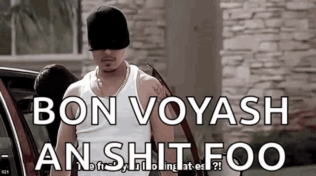 a man wearing a black hat and a white tank top is standing next to a red car and says bon voyash an shit foo