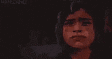 a man and a woman are standing next to each other in a dark room .