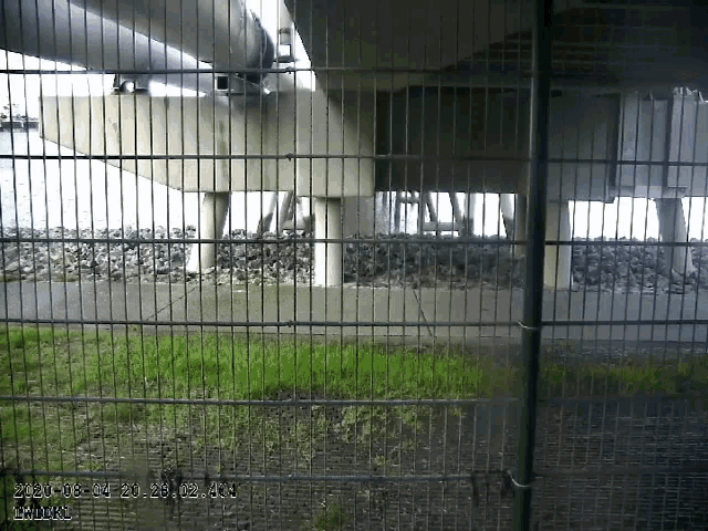 a picture of a bridge behind a fence with a time stamp of 7:20