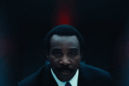 a dark room with a red light on the wall above the door